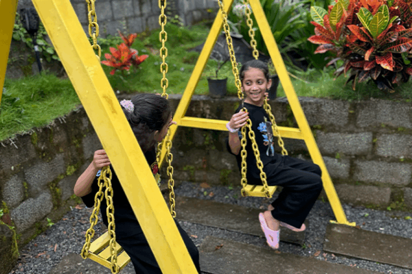 kids_sitting_in_swing_at_lavista